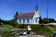 [Artist painting picture of classic white church in Brooklin, Maine]